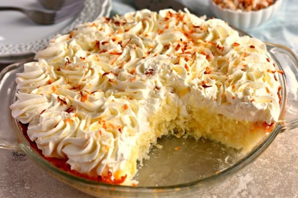 A Gluten-Free Coconut Cream Pie with a slice cut out of it.