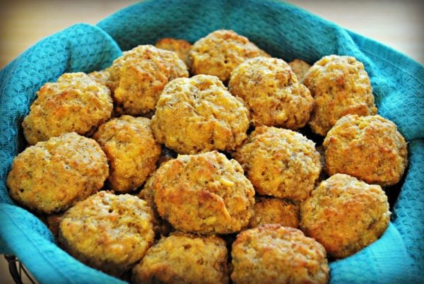 gluten-free sausage balls in a basket with a blue kitchen towel