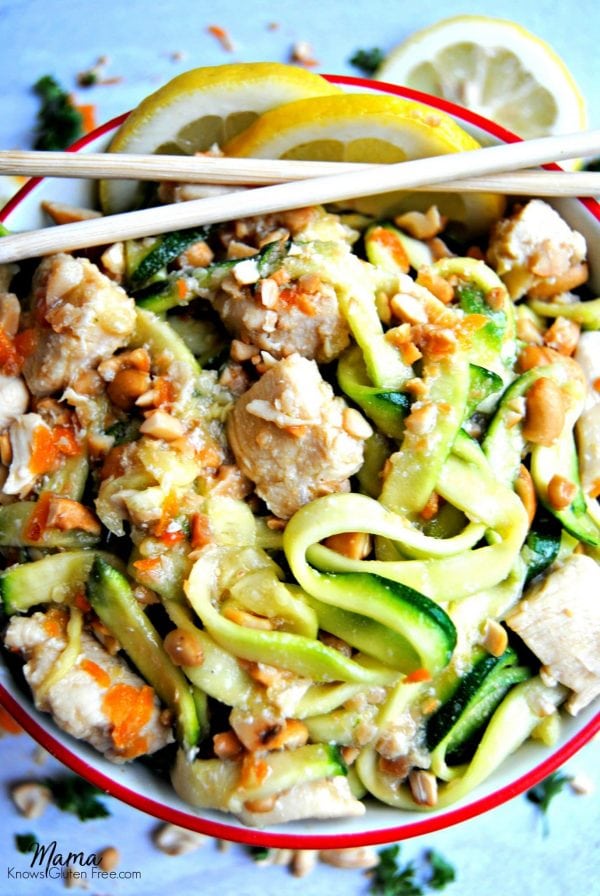 honey lemon ginger chicken zoodles in a bowl with lemon slices and chopsticks