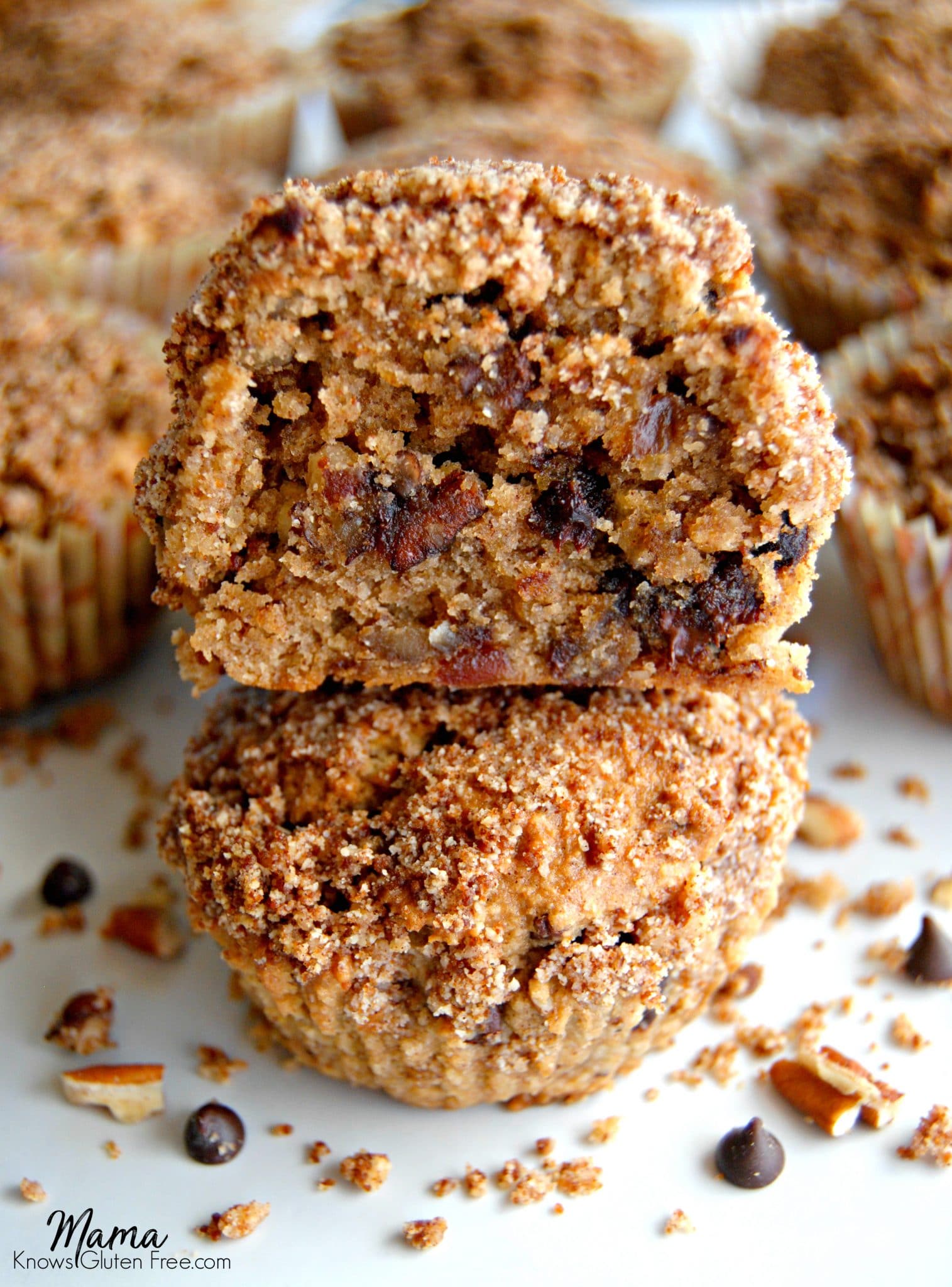 Paleo Chocolate Chip Pecan Pie Muffins, with one cut in half to show the texture.