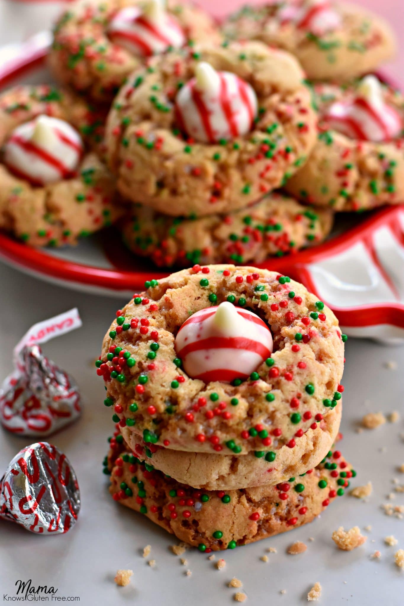 Gluten-Free Christmas Sugar Blossom Cookies stacked with cookie son a plate in the background.