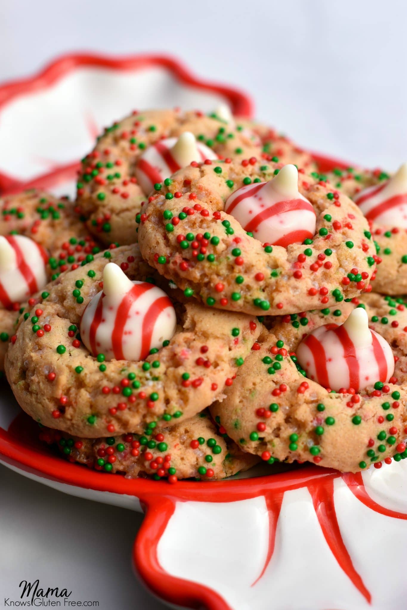 Gluten-Free Christmas Sugar Blossom Cookies stacked on a red and white plate