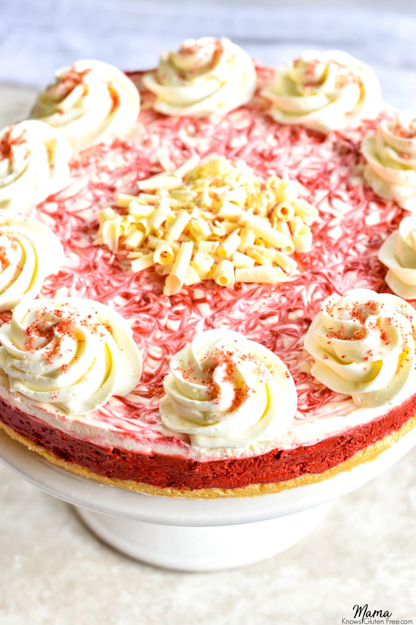 gluten-free red velvet no-bake cheesecake on a cake stand