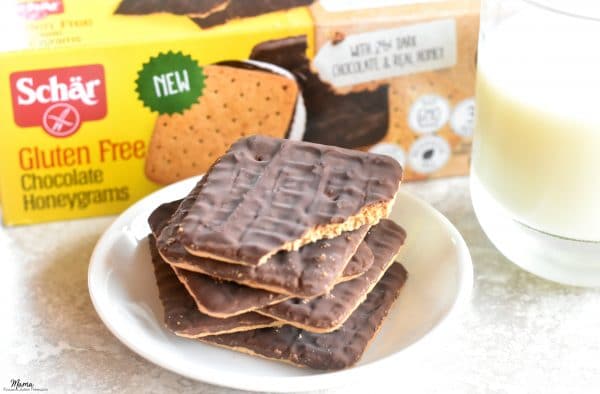 plate of chocolate honeygrams cookies with the box and a glass of milk in the background