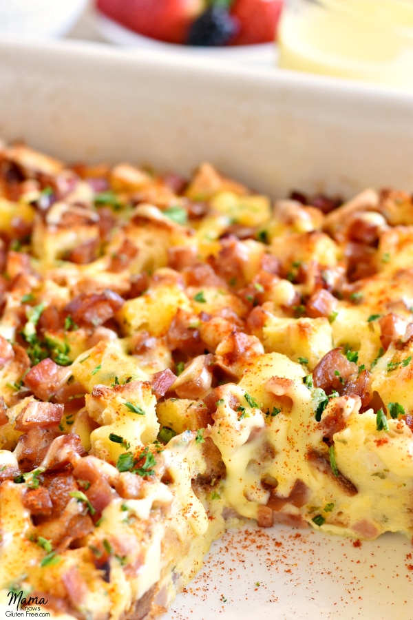 a pan of Gluten-Free Eggs Benedict Casserole with a serving cut out of it