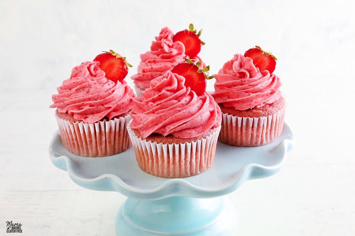 gluten-free strawberry cupcakes on a blue cake stand