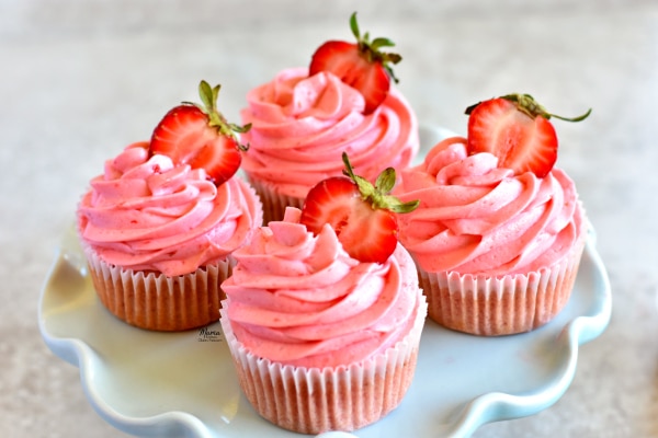 4 gluten-free strawberry cupcakes on a cake stand