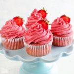 gluten-free strawberry cupcakes on a blue cake stand