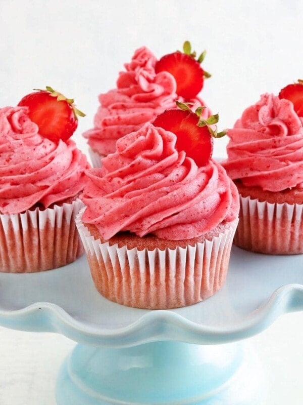 gluten-free strawberry cupcakes on a blue cake stand