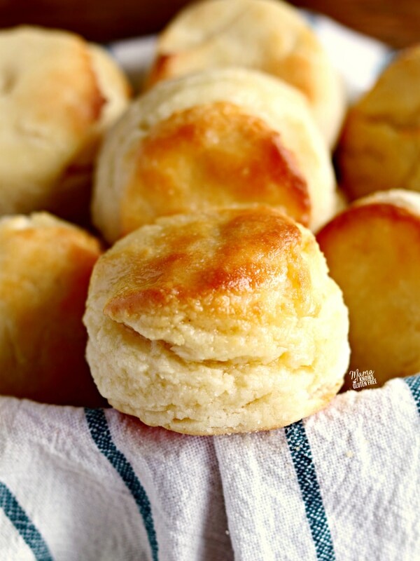 gluten-free biscuits in a basket with a white and blue kitchen towel