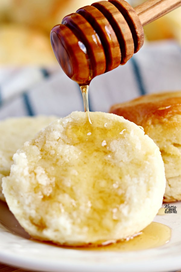 a gluten-free biscuit with honey being drizzled on it