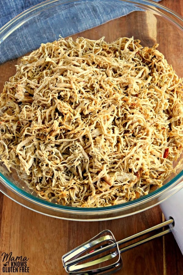 rotisserie style shredded chicken in a bowl that was easily shredded by a hand mixer