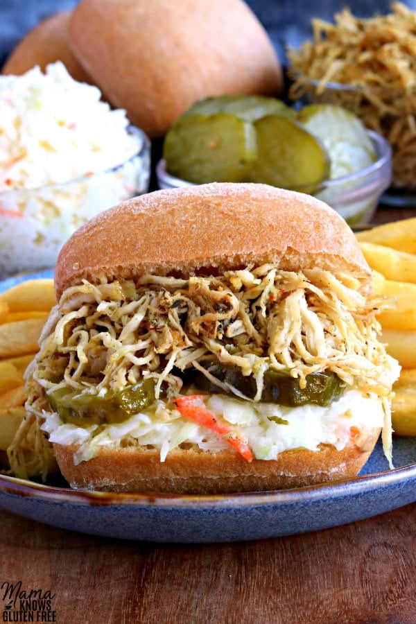 Shredded Chicken Sandwich with Coleslaw and Pickles on Ciabatta Bread with French Fries