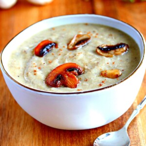 gluten-free cream of mushroom soup in a white bowl with a sppon