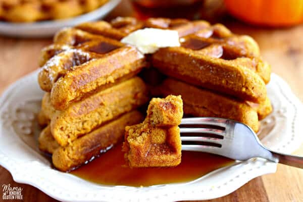 gluten-free pumpkin waffles bite shot with butter and syrup