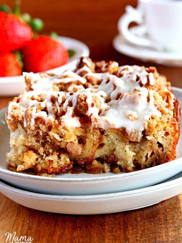 gluten-free french toast casserole on a white plate with coffee and strawberries in the background