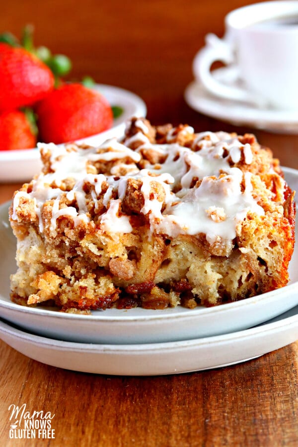 gluten-free french toast casserole on a plate with strawberries and coffee in the backgound