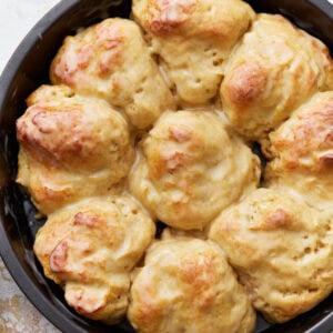 Overhead view of gluten-free dinner rolls in a cake pan.