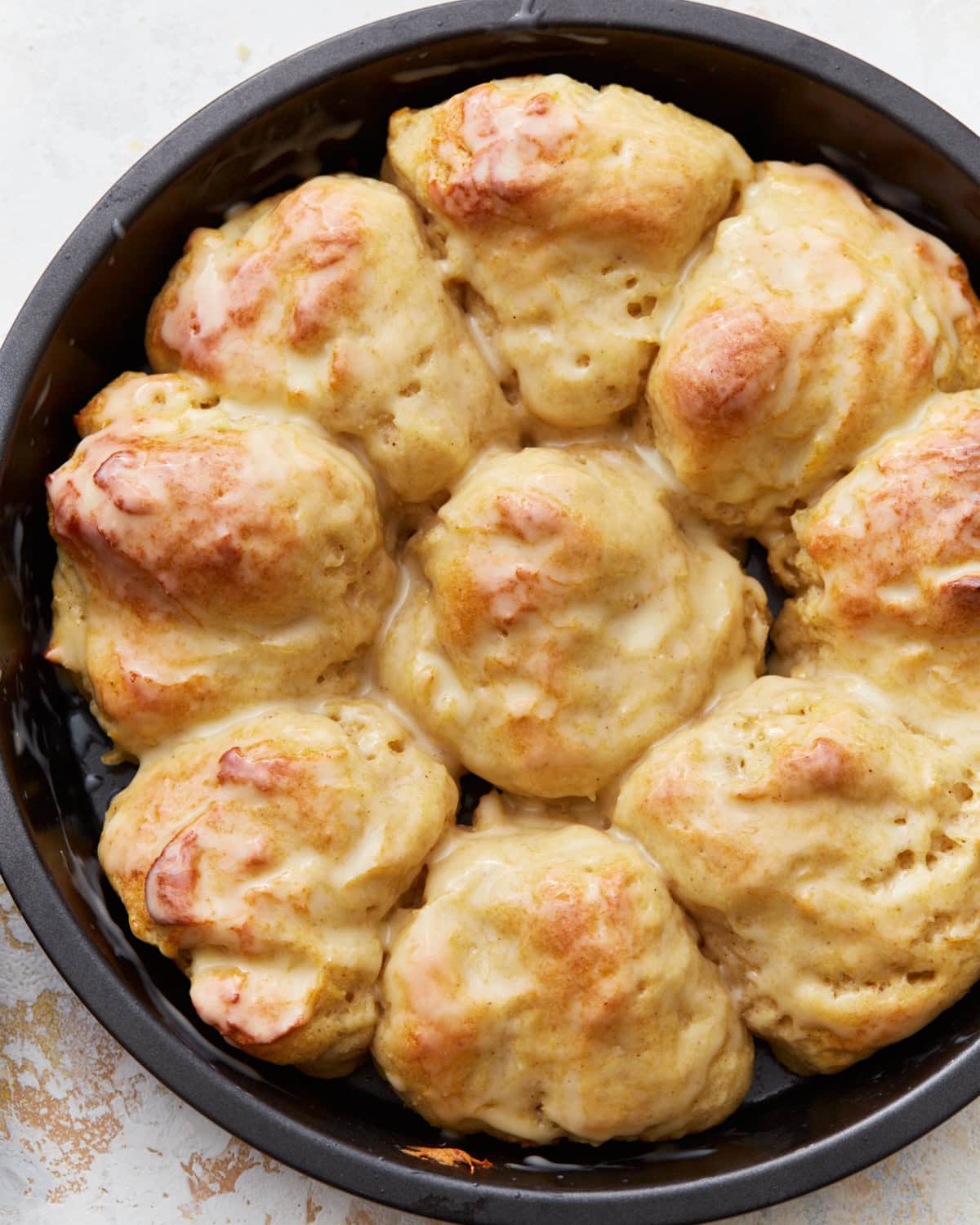 Overhead view of gluten-free dinner rolls in a cake pan.