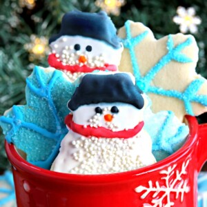 gluten-free cut out sugar cookies snowmen and snowflakes in a red snowflake cup