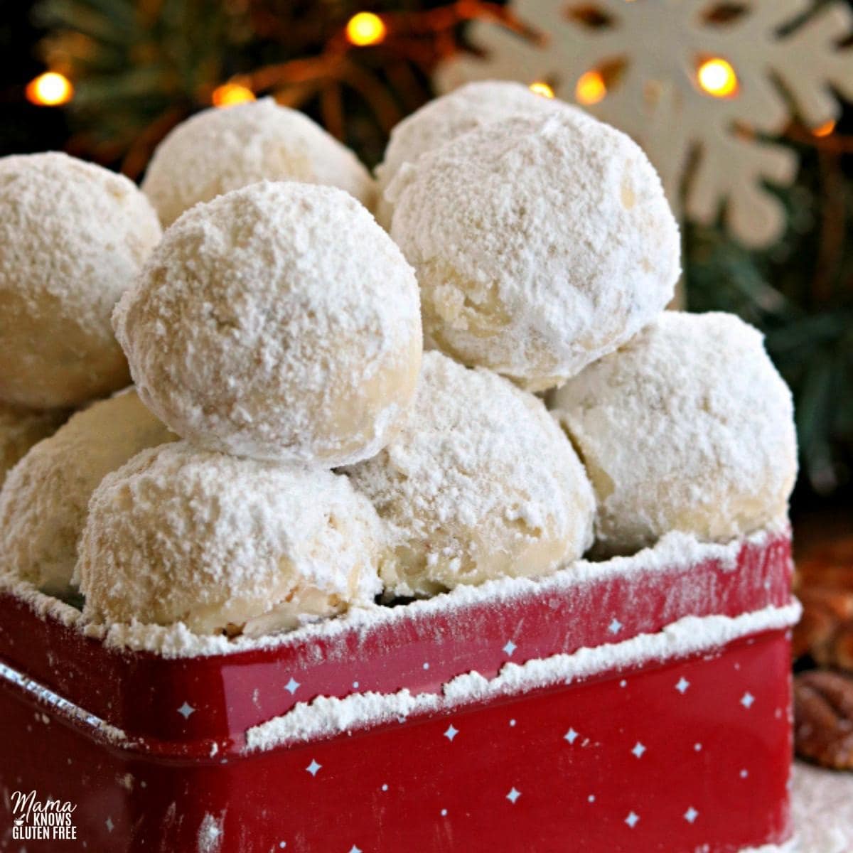 gluten-free snowball cookies in a red cookie tin