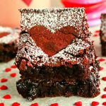 2 gluten-free red velvet brownies stacked on top of each other with heart candies
