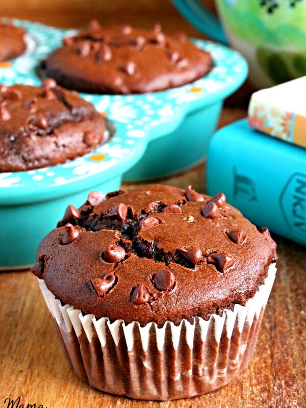 gluten-free double chocolate muffins with books, mug and muffins in the background