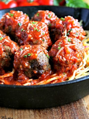pan with gluten-free meatballs on top of spaghetti topped tomato sauce