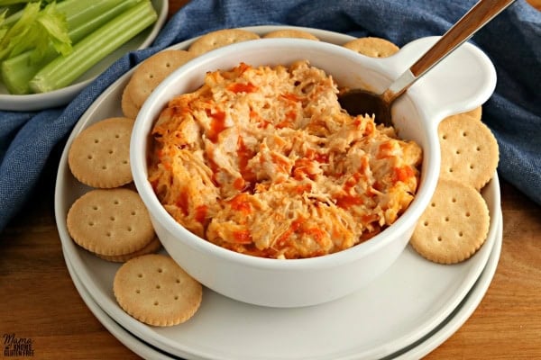 bowl of buffalo chicken dip with a spoon and crackers