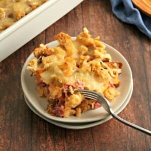 piece of ruben casserole on a plate with the casserole in the background