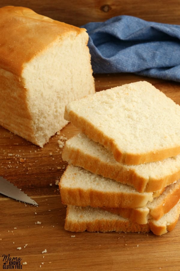 5 slices of gluten-free bread with the loaf in the background