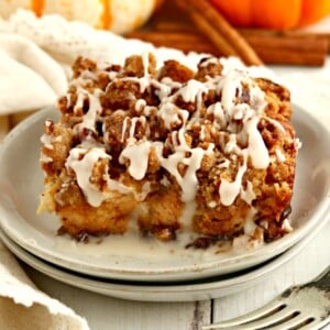 a serving of gluten-free pumpkin French toast casserole on a white plate with a fork