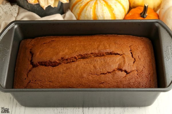 loaf of gluten-free pumpkin bread in a baking pan