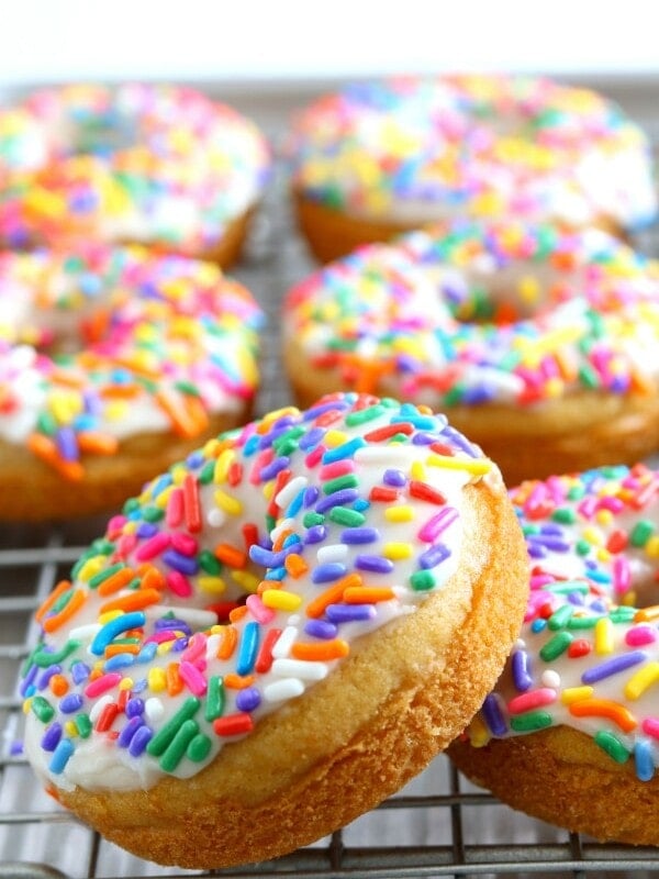 gluten-free vanilla donuts on a silver cooling rack