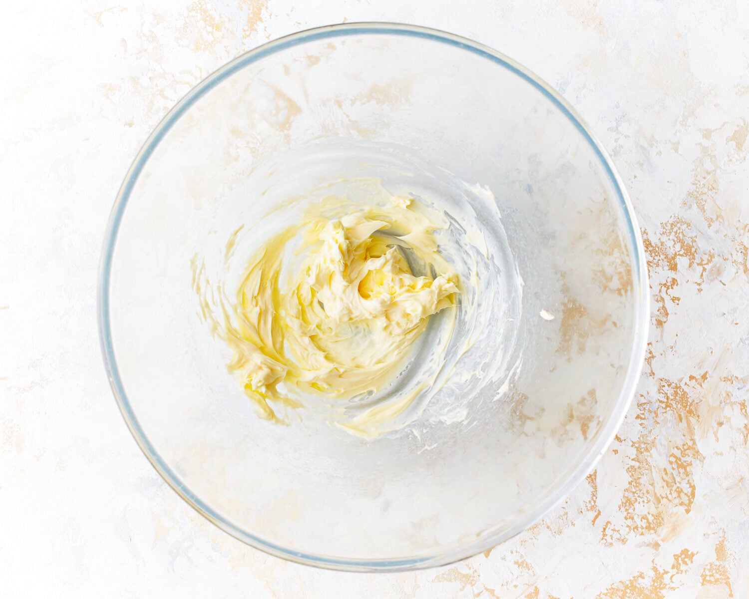 beaten butter in a glass bowl.