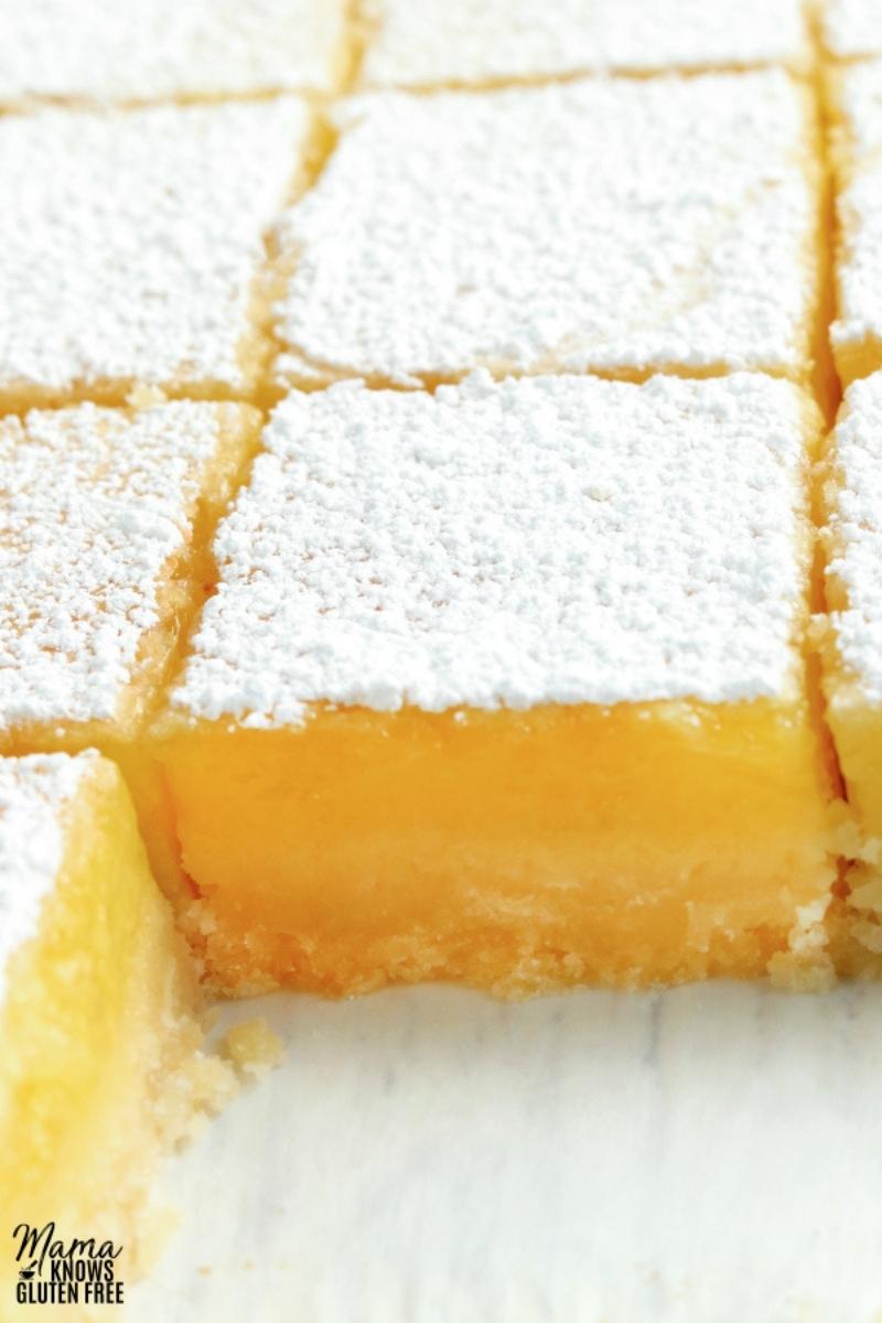 gluten-free lemon bars cut in a glass baking pan