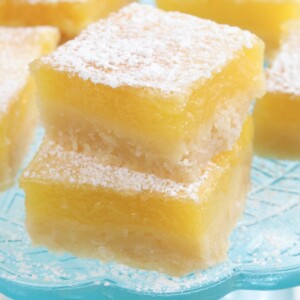 gluten-free lemon bars stacked on top of each other on a blue plate