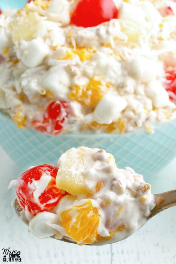spoonful of ambrosia salad with bowl of ambrosia in the background