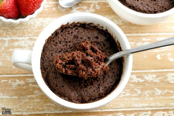 gluten-free chocolate mug cake with strawberries and another cake in the background