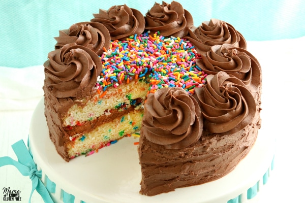 gluten-free vanilla birthday cake with slice cut out
