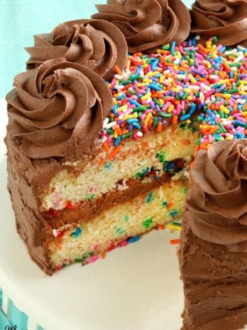 gluten-free birthday cake with slice cut out of it