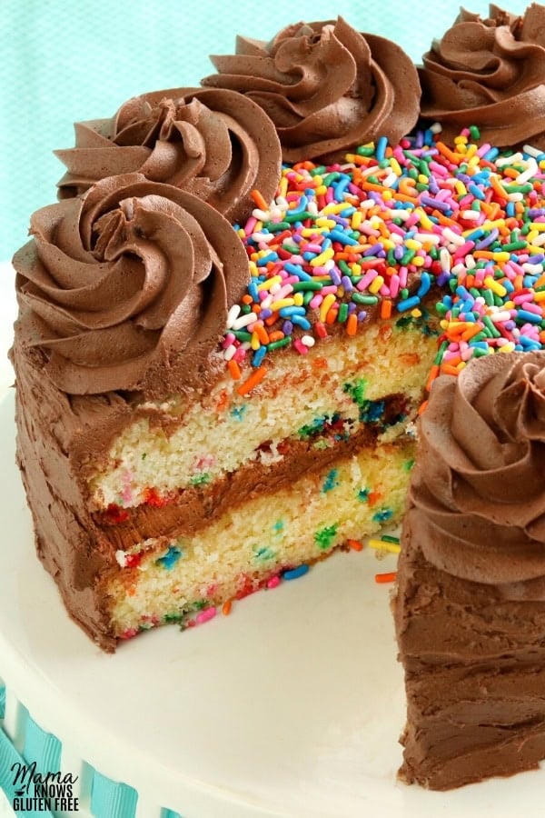 gluten-free birthday cake with slice cut out of it