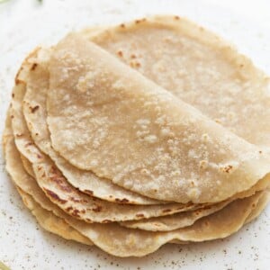 gluten-free tortillas folded on a white plate