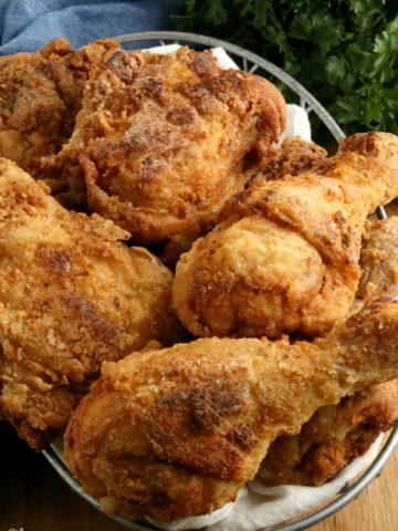 gluten-free fried chicken in a basket with parsley in the background