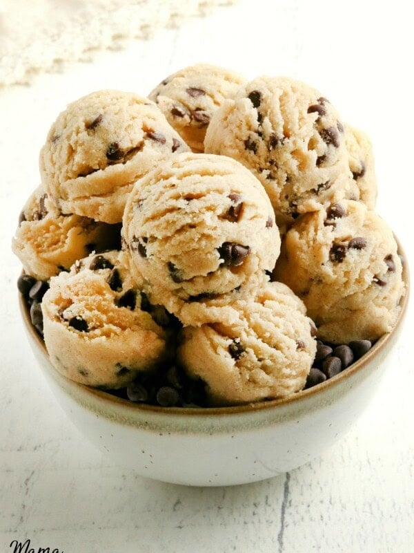 gluten-free cookie dough in a white bowl with cream napkin in the background