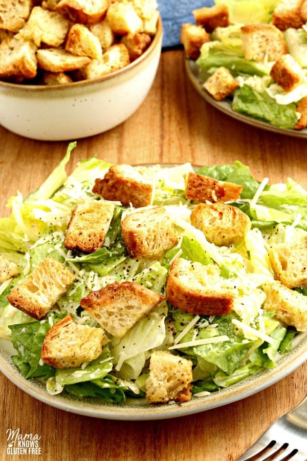 gluten-free croutons on a Caesar salad with a bowl of croutons in the background 