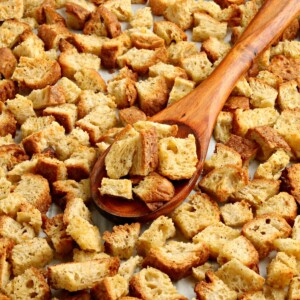 gluten-free croutons with a brown wooden spoon