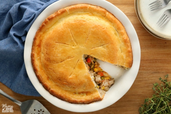 gluten-free chicken pot pie with plates and blue napkin in the background