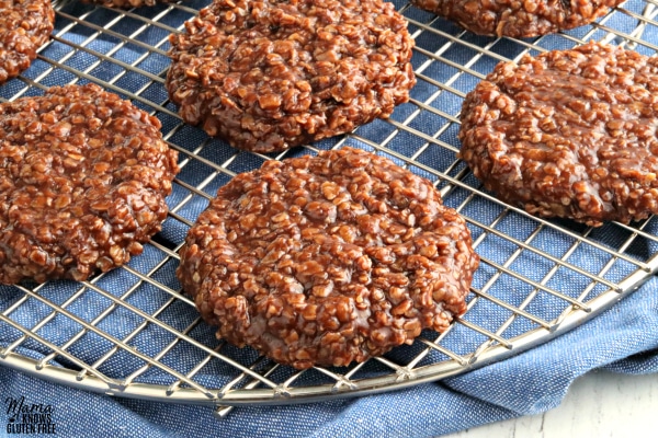 gluten-free no-bake cookies on a cooling rack with a blue kitchen towel