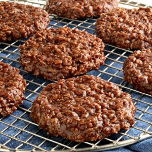 gluten-free no-bake cookies on a cooling rack with a blue kitchen towel underneath